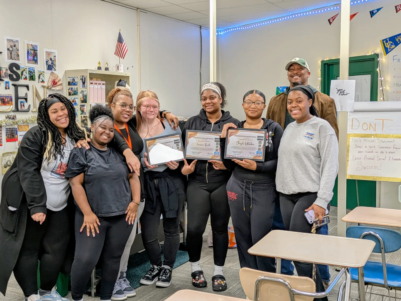 Young people and mentors holding completed training certificates