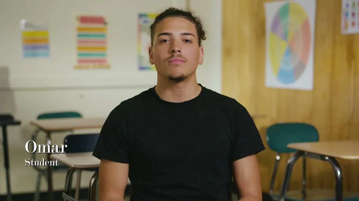 Omar, a student, seated for an interview in the youth prevention film